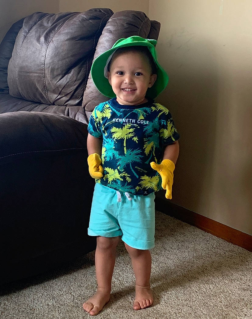 Kaden joined the competition — help win amazing prizes! baby_toddler_clothing, barefoot, baseball_cap, cap, comfort, couch, electric_blue, face, happy, head, human_body, human_leg, joy, leg, person, sleeve, smile, standing, studio_couch, t_shirt
