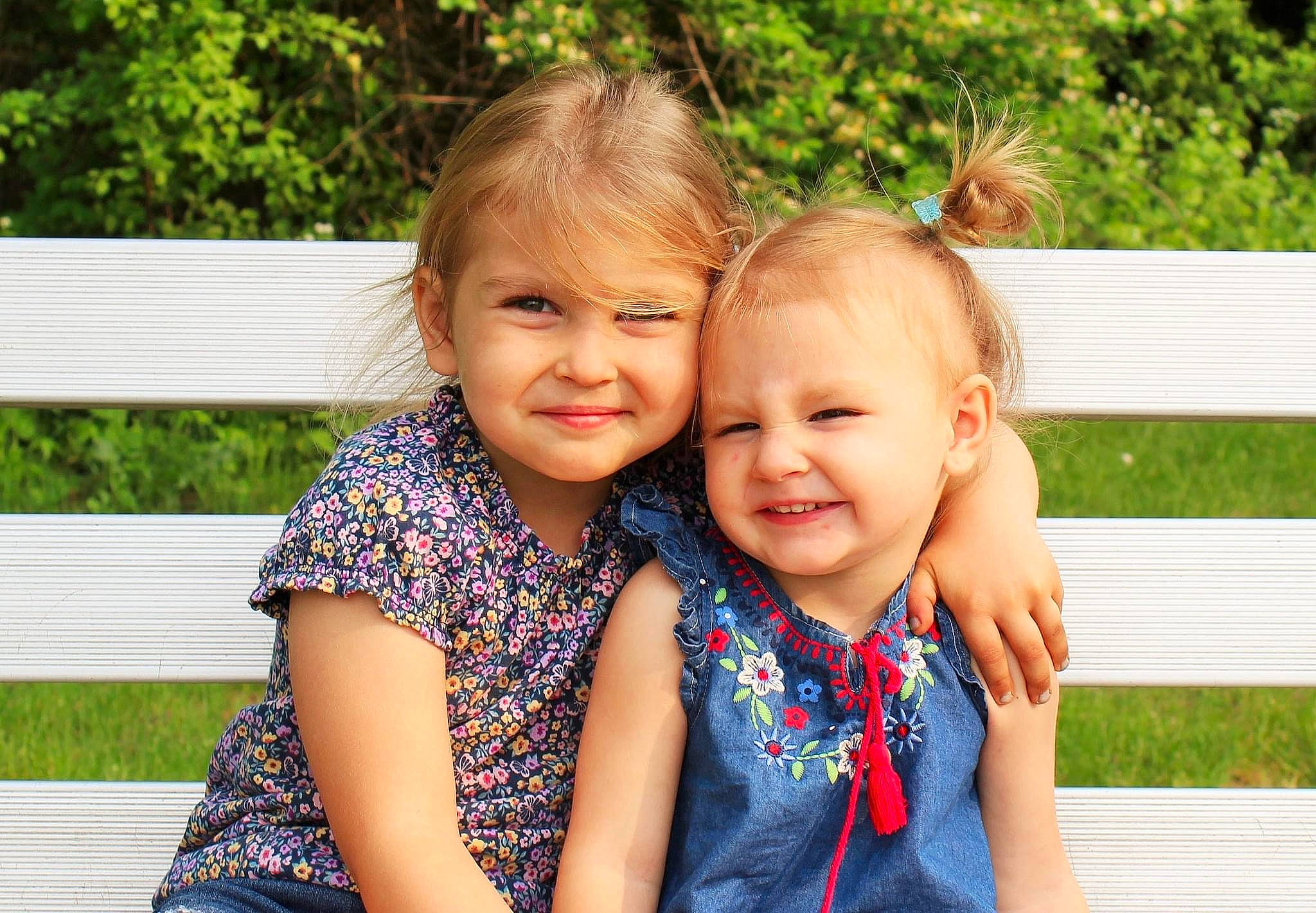 Gracie is registered to the contest to win money with this photo: baby, baby_toddler_clothing, blond, child, event, facial_expression, fun, gesture, grass, happy, joy, laugh, leisure, people_in_nature, person, recreation, sitting, smile, summer, t_shirt