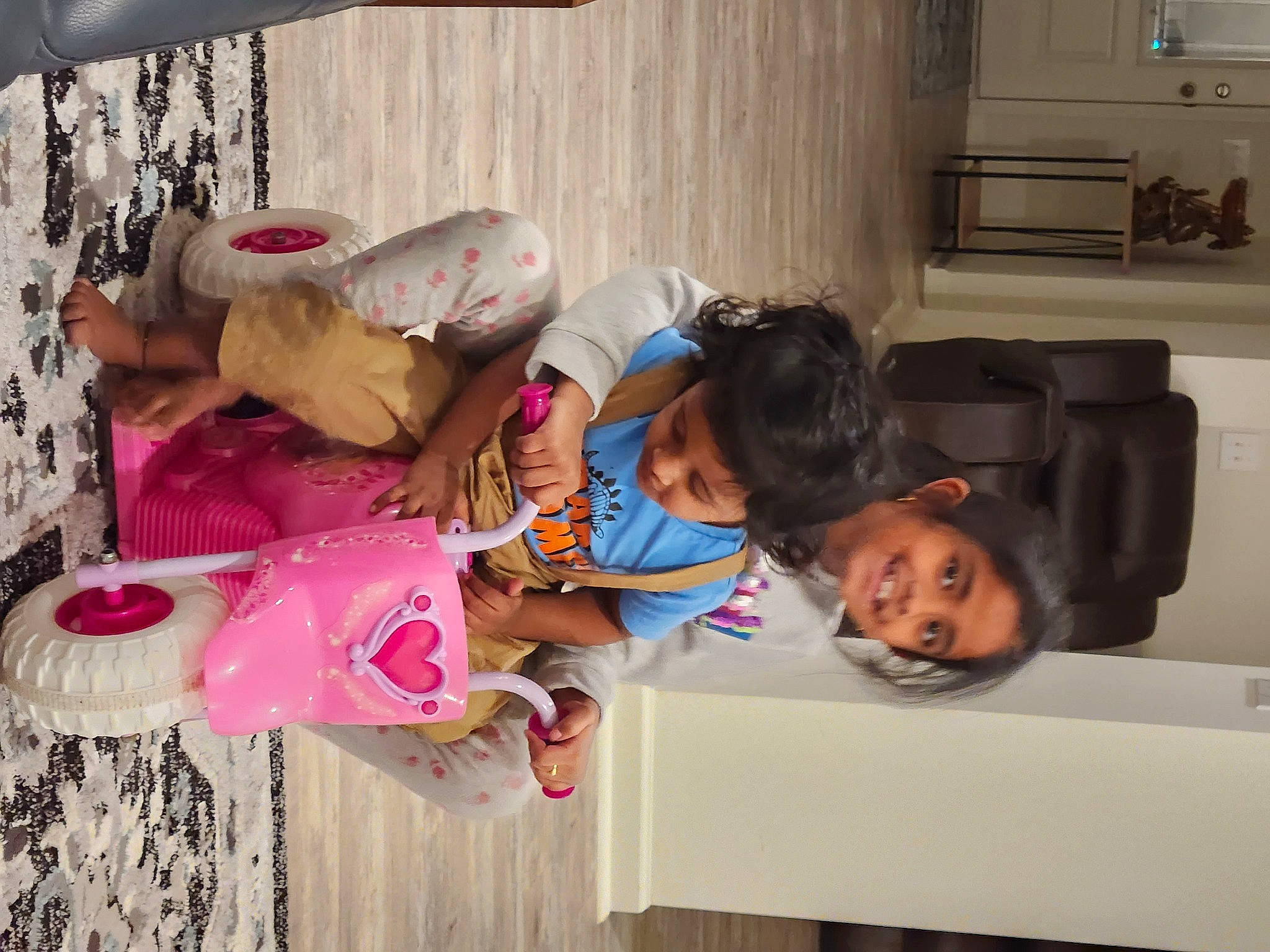 Varnika is registered to the contest to win money with this photo: child, comfort, flooring, fun, happy, home_appliance, house, joy, kitchen_appliance, leisure, magenta, microwave_oven, person, room, sitting, t_shirt, television, toddler, tree, vacation