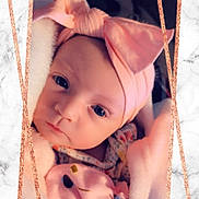 Jessie is registered to the contest to win money with this photo: baby, blanket, bow, child, closeup, cute, expression, eyes, face, frame, headband, indoors, infant, marble, newborn, pink, portrait, soft, warm, wrapped