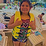 casual, child, concrete, daytime, family, fun, life_jacket, lounge_chair, outdoor, people, playground, poolside, recreation, smiling, summer, swimsuit, umbrella, vacation, water_park, water_slide