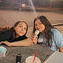 Cora is registered to the contest to win money with this photo: casual_clothing, child, children, cone, cup, drink, food, friends, happy, ice_cream, long_hair, night, outdoor, parking_lot, relaxing, sidewalk, smiling, straw, streetlight, table
