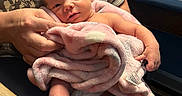 Havick joined the competition — help win amazing prizes! newborn, baby, infant, child, portrait, face, eyes, smiling, blanket, pink_blanket, adult, parent, holding, indoor, seated, chair, hospital, clothing, barefoot, family