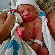 Havick is registered to the contest to win money with this photo: newborn, baby, infant, sleeping, hospital, hat, blanket, swaddled, portrait, face, skin, arms, legs, wristband, medical, parent, holding, indoor, couch, family