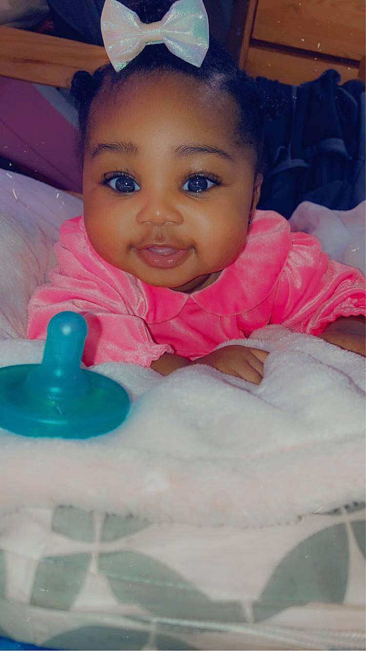 Faith is registered to the contest to win money with this photo: arm, baby, baby_products, cheek, child, chin, eyebrow, eyelash, facial_expression, finger, fun, happy, human_body, iris, mouth, nose, person, pink, skin, smile