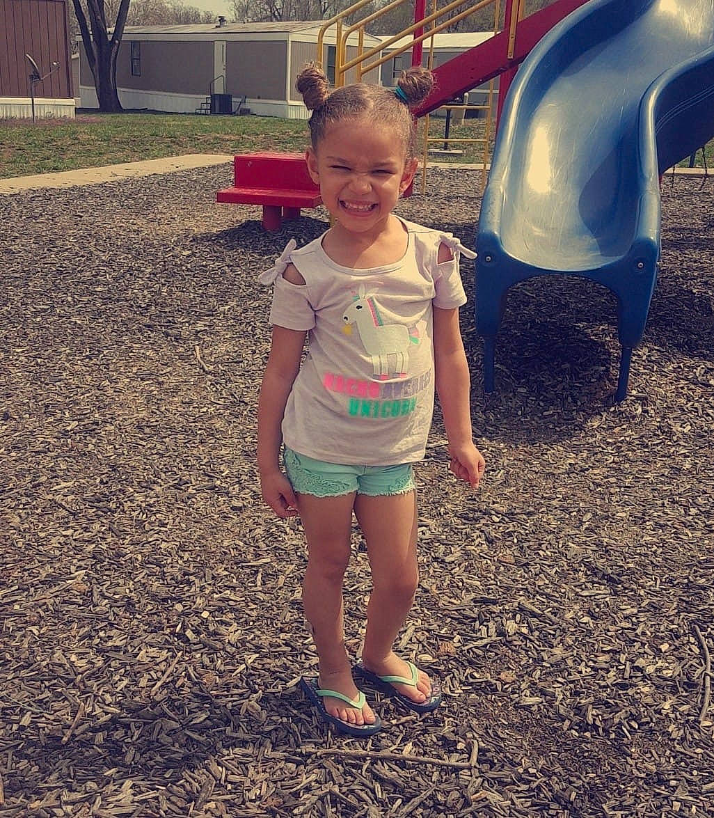 Ameliah is registered to the contest to win money with this photo: child, city, fun, happy, head, human_settlement, joy, leg, outdoor_play_equipment, people, person, play, playground, public_space, recreation, shorts, sky, smile, summer, toddler