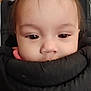baby, infant, child, closeup, face, eyes, forehead, hair, cheeks, nose, mouth, carrier, car_seat, padding, clothing, portrait, indoor, sitting, soft_texture, shelf