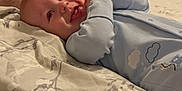 Riley-James joined the competition — help win amazing prizes! baby, infant, bed, bedding, pacifier, foot, adult, onesie, smile, happy, lying_down, indoor, blanket, remote_control, fabric, person, skin, hand, face, room