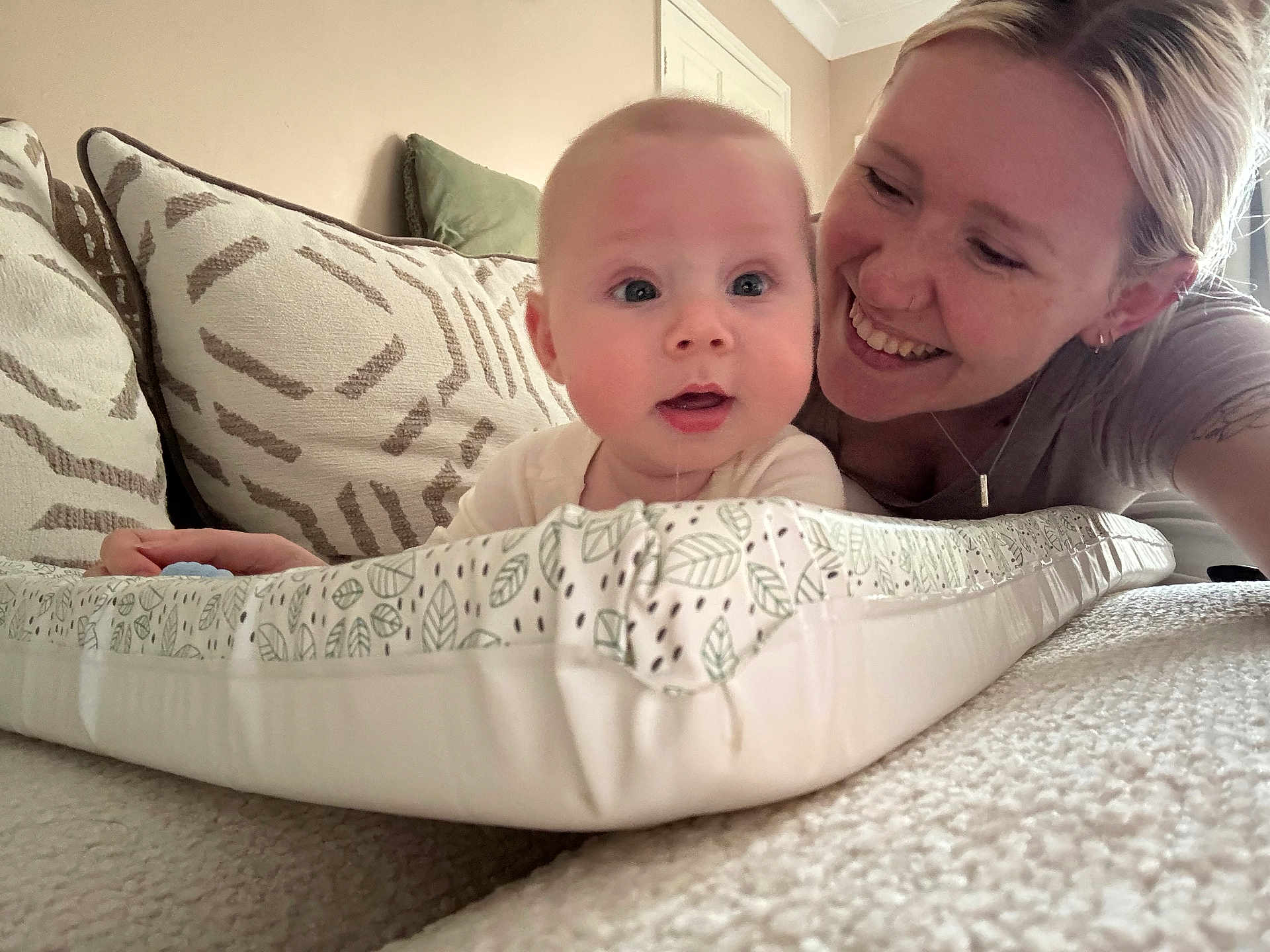 Riley-James joined the competition — help win amazing prizes! baby, woman, smile, face, cushion, carpet, pillow, indoor, person, child, laying, pattern, joy, happy, family, home, closeup, skin, head, expression
