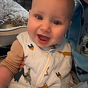 Riley-James joined the competition — help win amazing prizes! baby, smiling, child, onesie, animal_print, indoor, person, happy, face, closeup, childcare, infant, cute, apparel, portrait, family, warmth, toddler, cozy, expression