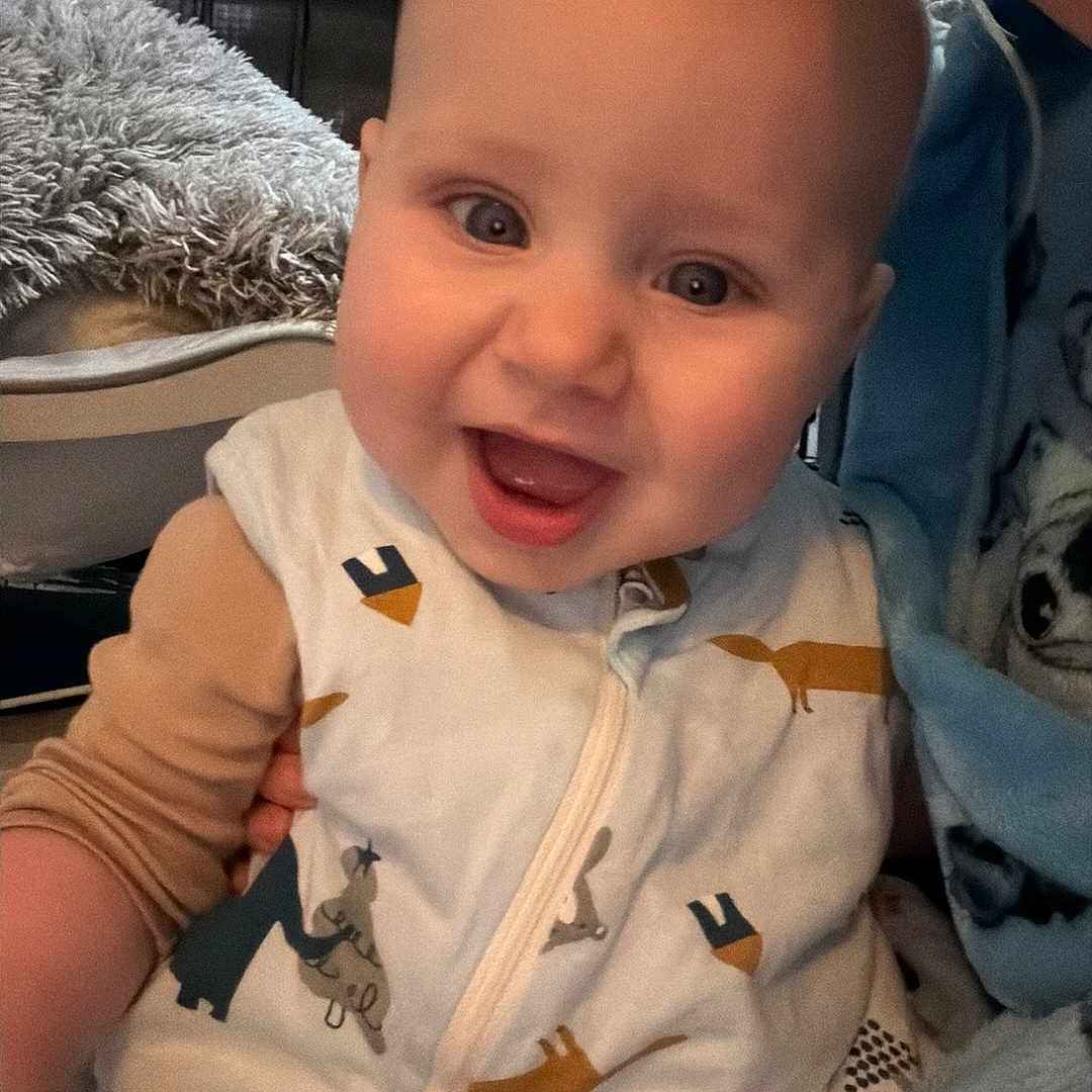 Riley-James joined the competition — help win amazing prizes! animal_print, apparel, baby, child, childcare, closeup, cozy, cute, expression, face, family, happy, indoor, infant, onesie, person, portrait, smiling, toddler, warmth