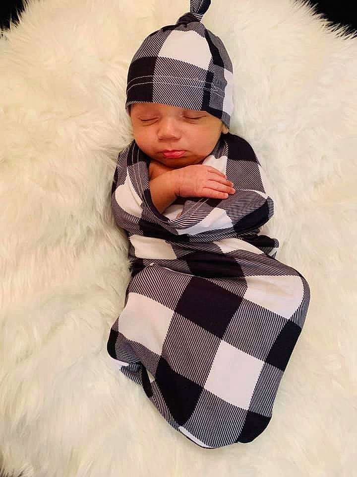 Maddix is registered to the contest to win money with this photo: baby, baby_sleeping, baby_toddler_clothing, beanie, bonnet, comfort, costume_accessory, fur, fur_clothing, headgear, headwear, knit_cap, pattern, person, plaid, snow, tartan, textile, toddler, winter