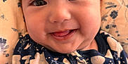 Ellie Victoria is registered to the contest to win money with this photo: baby, blanket, cheeks, child, closeup, cute, face, floral_pattern, happy, indoors, infant, moon, onesie, patterned_clothing, portrait, sleepwear, smile, stars, tongue, zipper