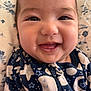 baby, smiling, close_up, face, infant, happy, clothing, zipper, pattern, stars, moon, blanket, fabric, cute, portrait, child, indoors, young, skin, expressive