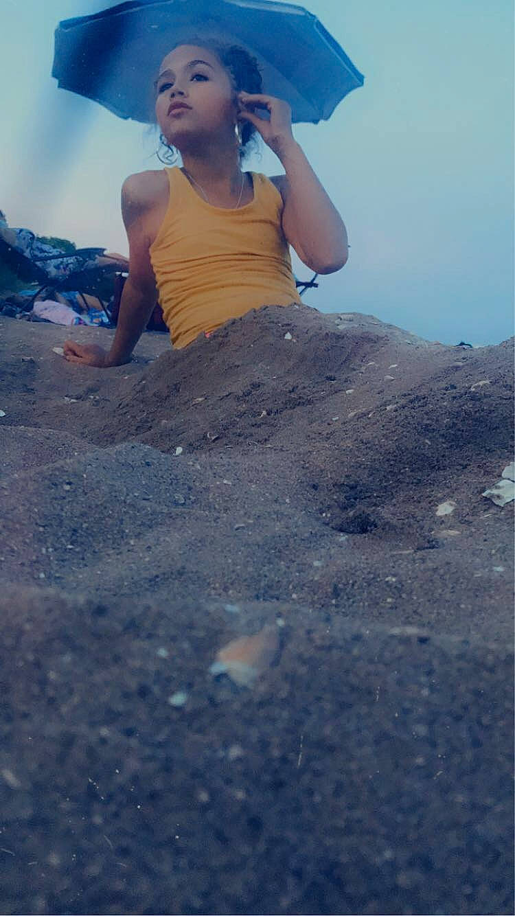 Kelli joined the competition — help win amazing prizes! asphalt, elbow, electric_blue, flash_photography, fun, happy, human_leg, landscape, leisure, ocean, people_in_nature, person, recreation, rock, sitting, sky, soil, t_shirt, thigh, travel