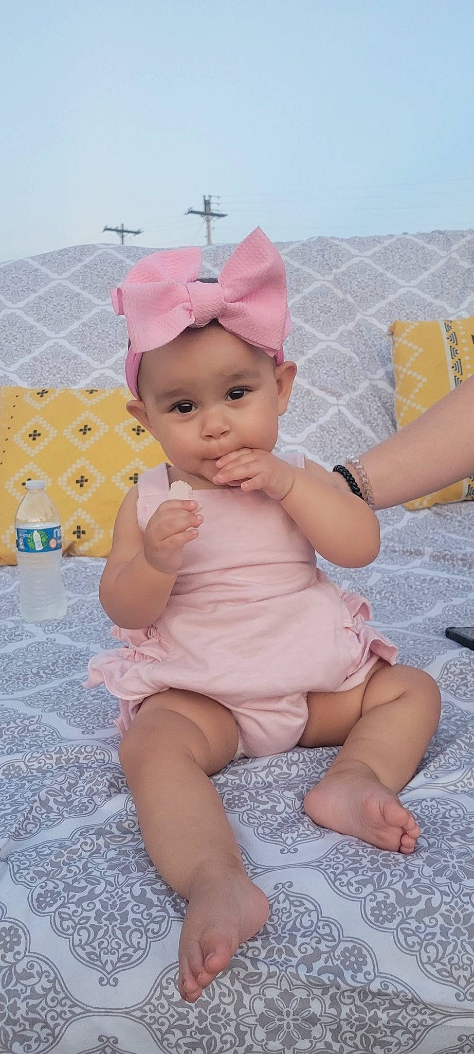 Lilah is registered to the contest to win money with this photo: baby, baby_toddler_clothing, barefoot, cap, child, costume_hat, foot, fun, happy, hat, headgear, headwear, human_leg, neck, party_supply, person, pink, skin, sun_hat, textile