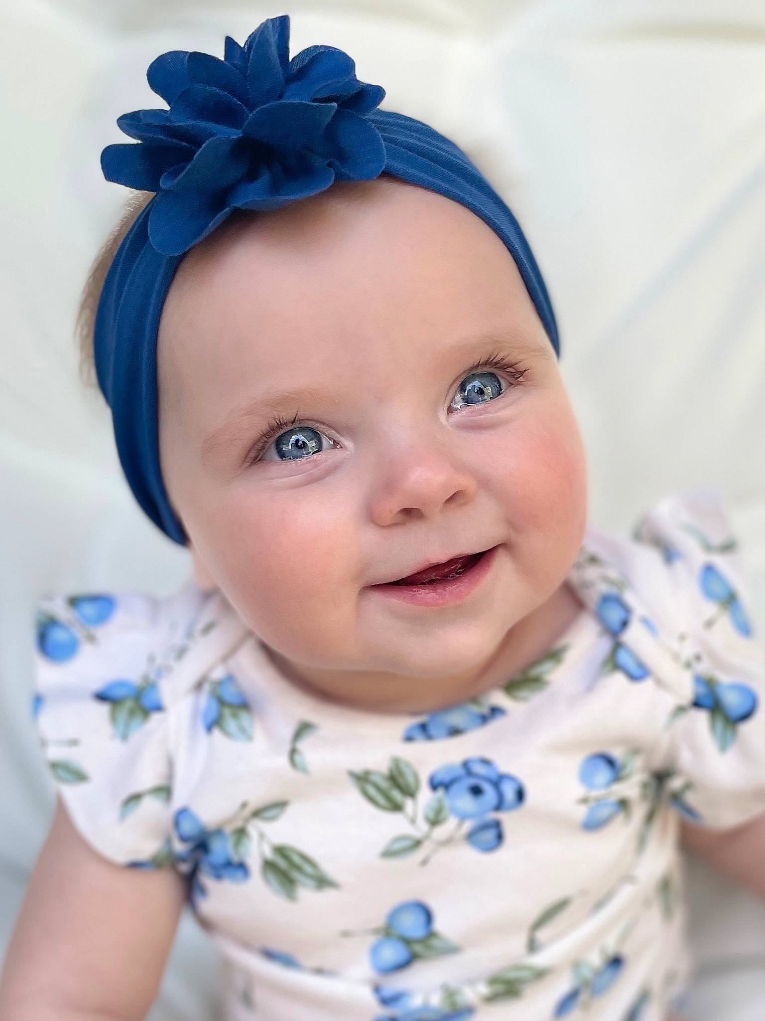 Ainsley is registered to the contest to win money with this photo: baby_toddler_clothing, blue, cheek, chin, clothing, eye, eyebrow, face, facial_expression, forehead, hairstyle, happy, head, headwear, iris, lip, nose, person, purple, skin