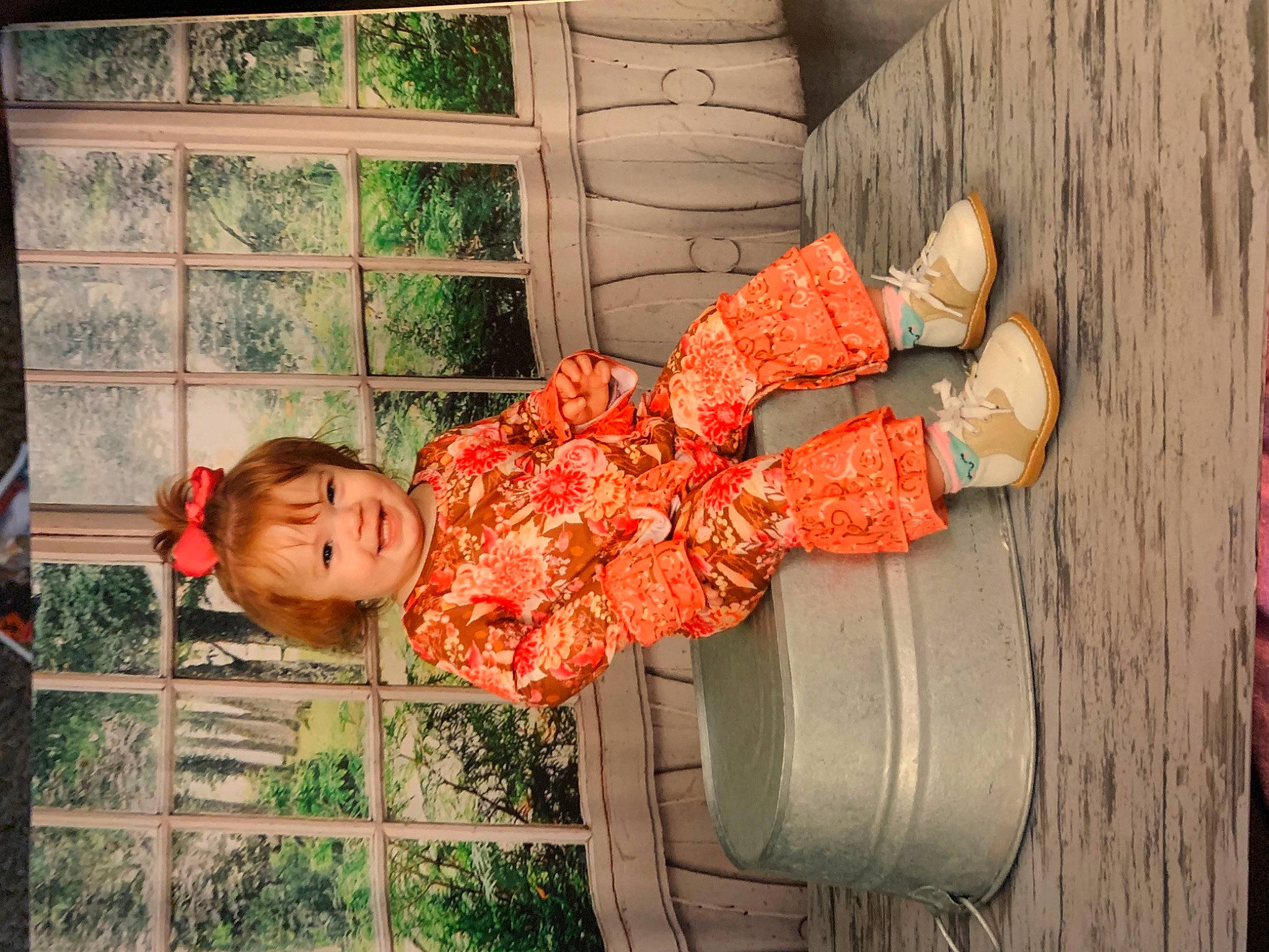 Mckinley is registered to the contest to win money with this photo: baby_toddler_clothing, child, door, fence, fun, grass, happy, joy, leisure, orange, peach, person, plant, sitting, toddler, tree, vacation, window, wood