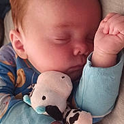 Isiah joined the competition — help win amazing prizes! baby, sleeping, plush_toy, cow, pajamas, blue_clothing, infant, hand, closed_eyes, cuddle, soft_toy, resting, peaceful, cute, child, bedtime, comfort, skin, face, fingers