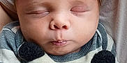 Isiah is registered to the contest to win money with this photo: baby, infant, sleeping, closed_eyes, striped_clothing, mittens, person, child, cute, young, soft, comfort, peaceful, face, head, portrait, newborn, skin, hair, resting