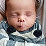 baby, infant, sleeping, closed_eyes, striped_clothing, mittens, person, child, cute, young, soft, comfort, peaceful, face, head, portrait, newborn, skin, hair, resting