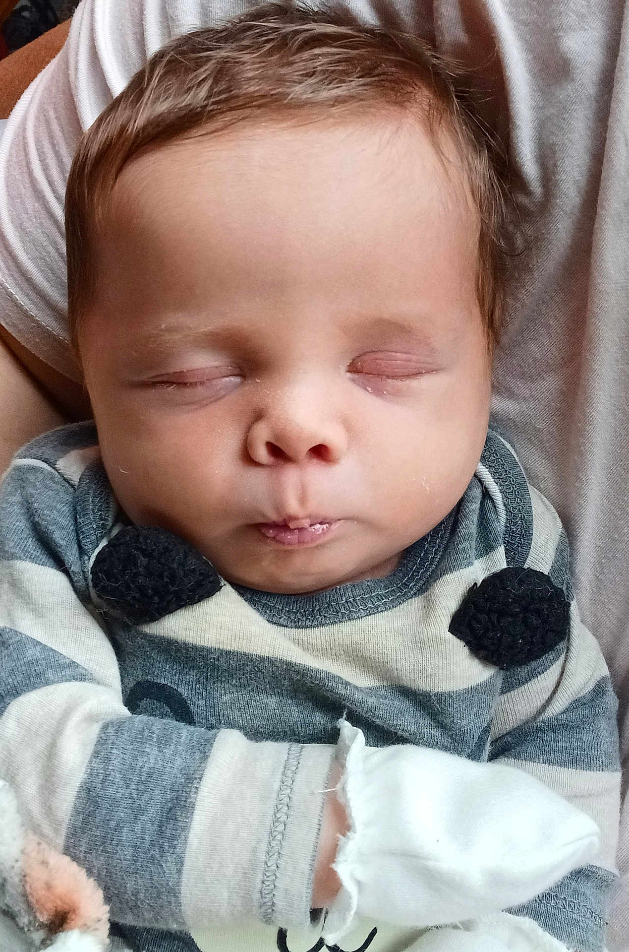 Isiah is registered to the contest to win money with this photo: baby, infant, sleeping, closed_eyes, striped_clothing, mittens, person, child, cute, young, soft, comfort, peaceful, face, head, portrait, newborn, skin, hair, resting