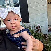 Kinsley joined the competition — help win amazing prizes! baby, bow, building, casual, child, curious, daylight, dress, face, grass, hand, headband, holding, outdoor, person, plant, polka_dot, portrait, skin, window