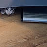 Simon is registered to the contest to win money with this photo: cat, kitten, animal, pet, white_cat, gray_cat, face, eyes, ears, hiding, under_furniture, indoors, wooden_floor, heater, radiator, home, floor, crouching, peekaboo, blurry