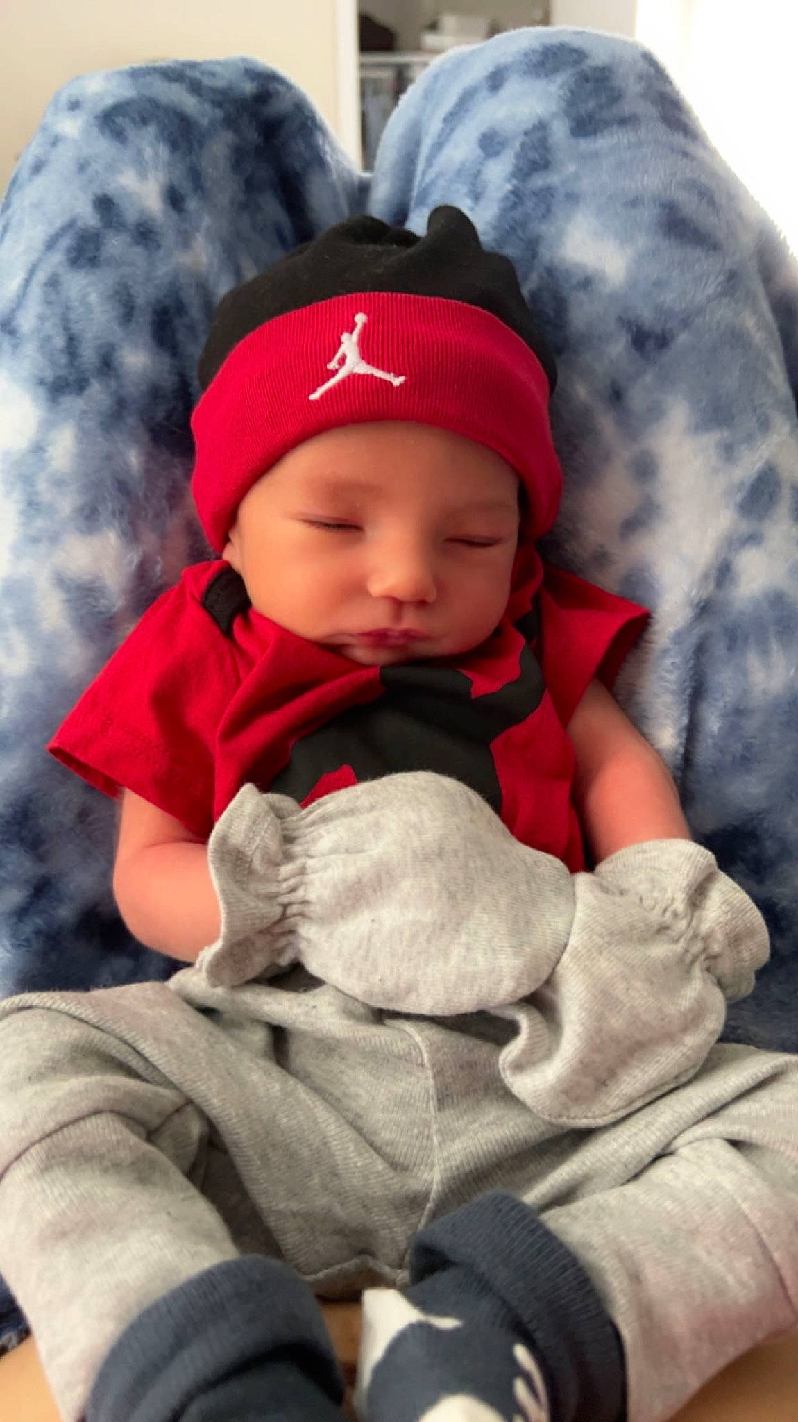 Kyson is registered to the contest to win money with this photo: baby, baby_toddler_clothing, beanie, cap, carmine, cheek, child, comfort, fur, headgear, headwear, hoodie, knit_cap, linens, person, sitting, skin, sleeve, textile, toddler