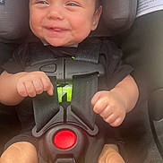 Silas is registered to the contest to win money with this photo: accessories, baby, belt, bodypart, car, car_interior, carseat, clothing, cushion, face, finger, hand, head, homedecor, person, photography, portrait, t_shirt, transportation, vehicle