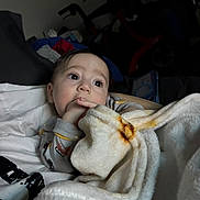 Oliver joined the competition — help win amazing prizes! baby, blanket, child, face, hand, indoor, person, portrait, sleepwear, soft, thoughtful, young, cozy, comfort, candid, infant, expression, warm, fingers, resting