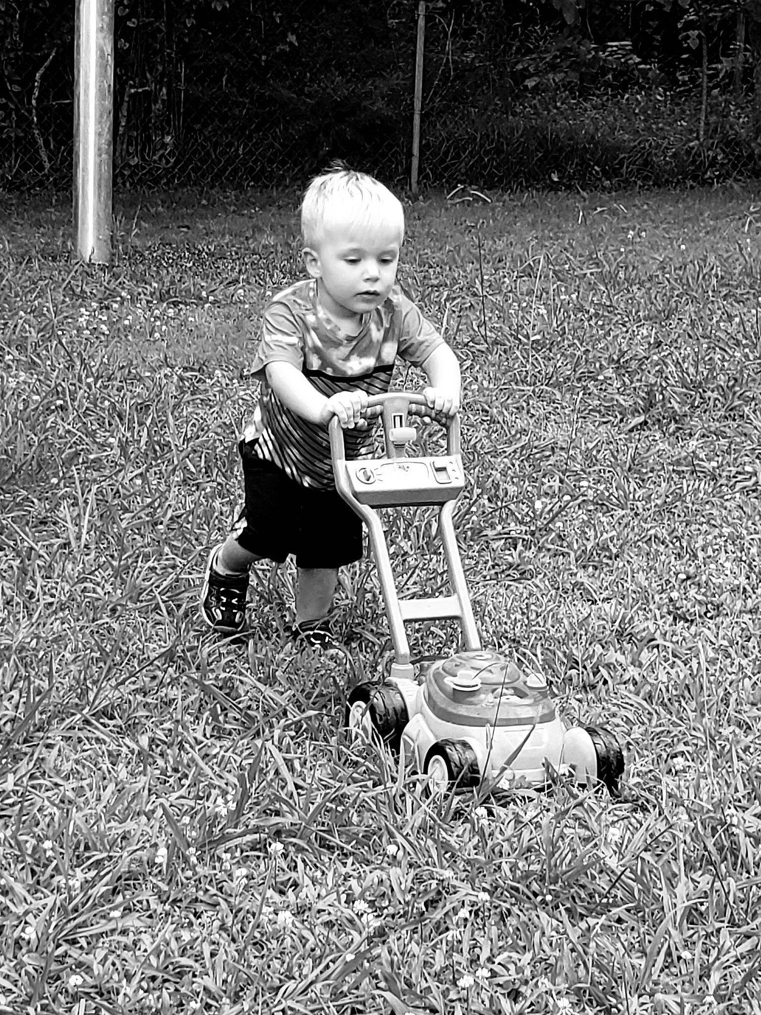 Weylyn is registered to the contest to win money with this photo: black_and_white, child, grass, lawn, monochrome, person, photography, plant, play, sitting, stock_photography, style, toddler, vehicle, yard