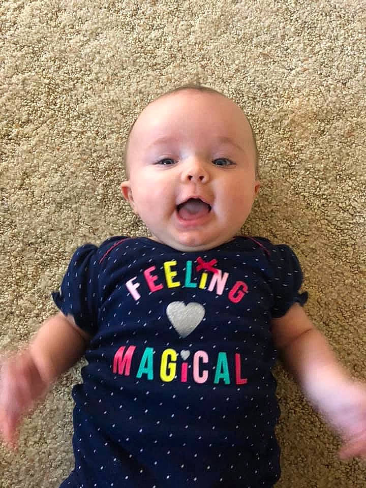 Allyson is registered to the contest to win money with this photo: baby, baby_products, baby_toddler_clothing, cheek, child, cool, face, facial_expression, fun, happy, head, nose, outerwear, pattern, person, product, skin, sleeve, smile, t_shirt