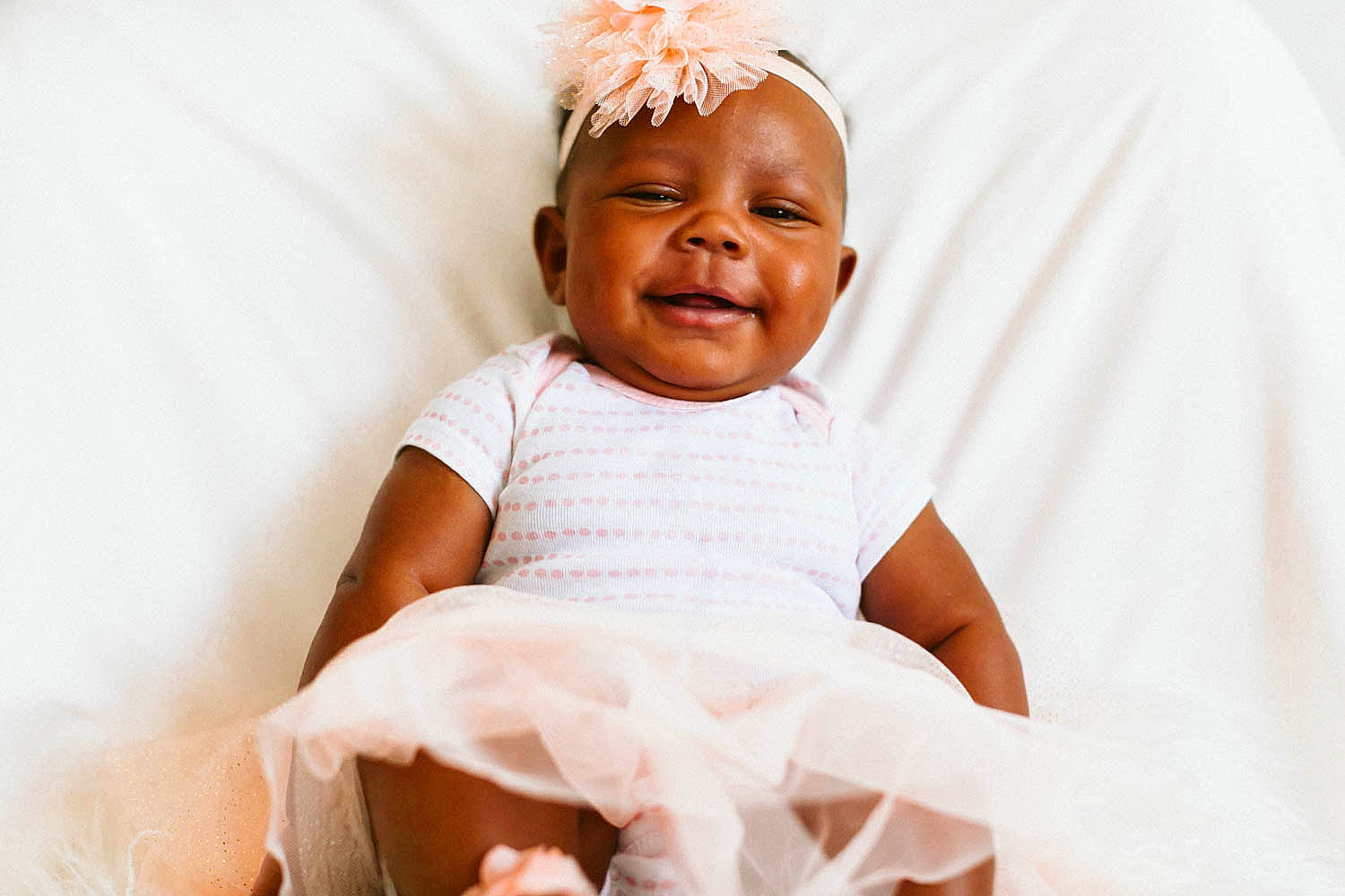 Alex'Zandria Wilson joined the competition — help win amazing prizes! arm, baby, baby_toddler_clothing, child, comfort, event, face, fashion_accessory, flash_photography, gesture, happy, head, joy, linens, magenta, peach, person, portrait_photography, sleeve, smile