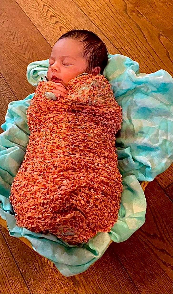 Melia is registered to the contest to win money with this photo: aqua, baby, baby_toddler_clothing, comfort, crochet, knitting, laminate_flooring, nap, peach, person, sleep, teal, textile, thread, turquoise, wood_flooring, wool, woolen