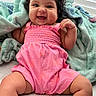 baby, blanket, bright, cheeks, child, cozy, curly_hair, cute, face, happy, indoors, infant, person, pink_clothing, portrait, romper, sitting, skin, smiling, soft_texture