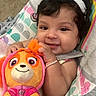 baby, baby_seat, bow, bracelet, carpet, child, curly_hair, cute, happy, headband, indoor, infant, orange, patterned, person, pink, plush_toy, portrait, smile, soft_toy