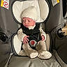 Xayla joined the competition — help win amazing prizes! baby, infant, car_seat, knit_hat, onesie, seatbelt, child, newborn, indoors, fabric, padded, cute, sleepy, sitting, small_hands, clothing, safety, resting, person, soft