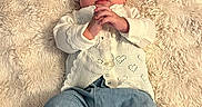 Madison is registered to the contest to win money with this photo: baby, blanket, blue_pants, calm_expression, child, cozy, cute, fashion, fluffy, hands_clasped, headband, indoor, infant, lying_down, portrait, red_bow, soft_texture, warm_colors, white_cardigan, young_child