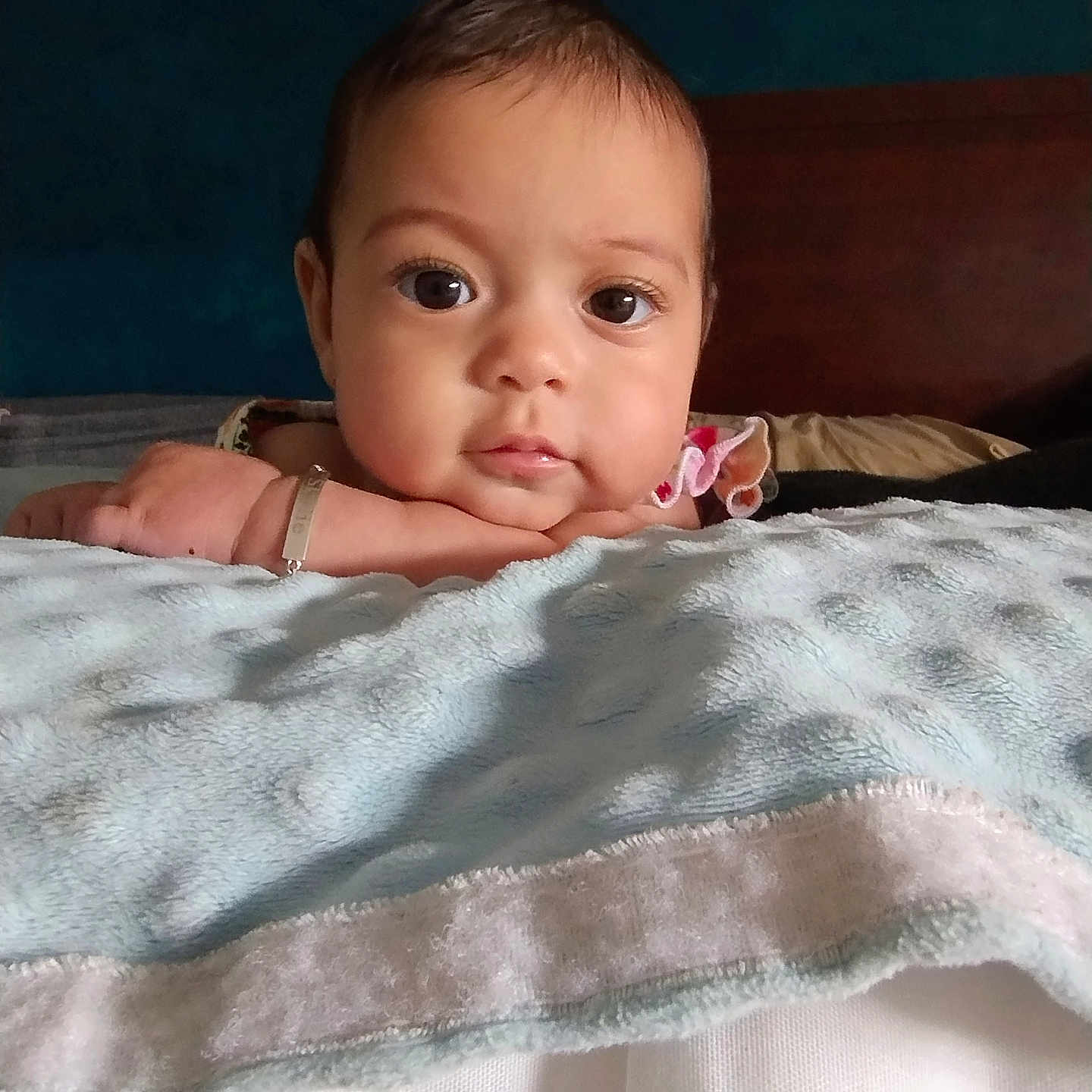 Skylie is registered to the contest to win money with this photo: baby, bedroom, blanket, calm, child, closeup, cozy, curious, cute, expression, face, hand, head, indoors, infant, portrait, resting, skin, soft, young