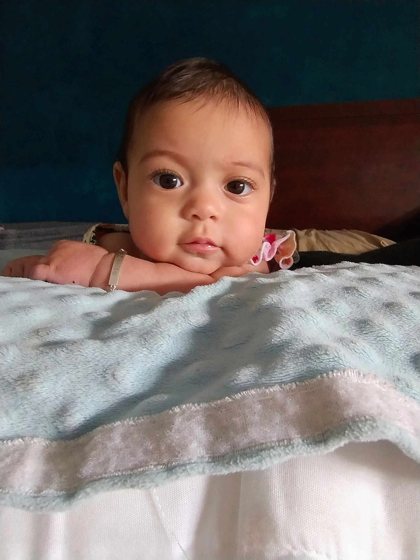 Skylie is registered to the contest to win money with this photo: baby, bedroom, blanket, calm, child, closeup, cozy, curious, cute, expression, face, hand, head, indoors, infant, portrait, resting, skin, soft, young