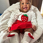 Kaliyajae joined the competition — help win amazing prizes! baby, smiling, child, red_bow, strawberry, white_socks, red_skirt, white_blouse, happy, cute, infant, portrait, indoors, soft_blanket, fashion, headband, sitting, playful, adorable, closeup