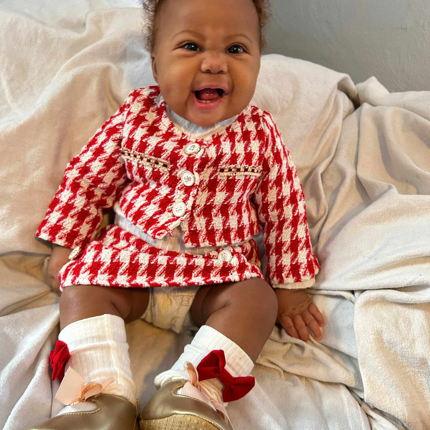 Kaliyajae joined the competition — help win amazing prizes! baby, blanket, bow, child, clothing, cute, face, fashion, happy, indoor, infant, person, portrait, red, seated, shoes, smiling, socks, white, young