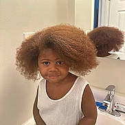 Jamos is registered to the contest to win money with this photo: child, afro_hair, bathroom, sink, mirror, white_shirt, smile, cute, person, reflection, counter, indoor, young_child, hair, face, casual, portrait, skin, faucet, container
