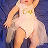 Brynlee is registered to the contest to win money with this photo: accessories, baby, bodypart, clothing, costume, crown, dress, face, finger, hand, hat, head, jewelry, necklace, newborn, person, photography, portrait, sitting, tiara