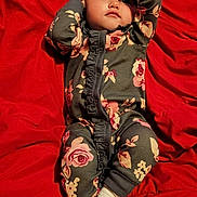 Brynlee joined the competition — help win amazing prizes! baby, bodypart, clothing, coat, couch, face, finger, furniture, hand, hat, head, hood, hosiery, jacket, pajamas, pants, person, photography, portrait, sock