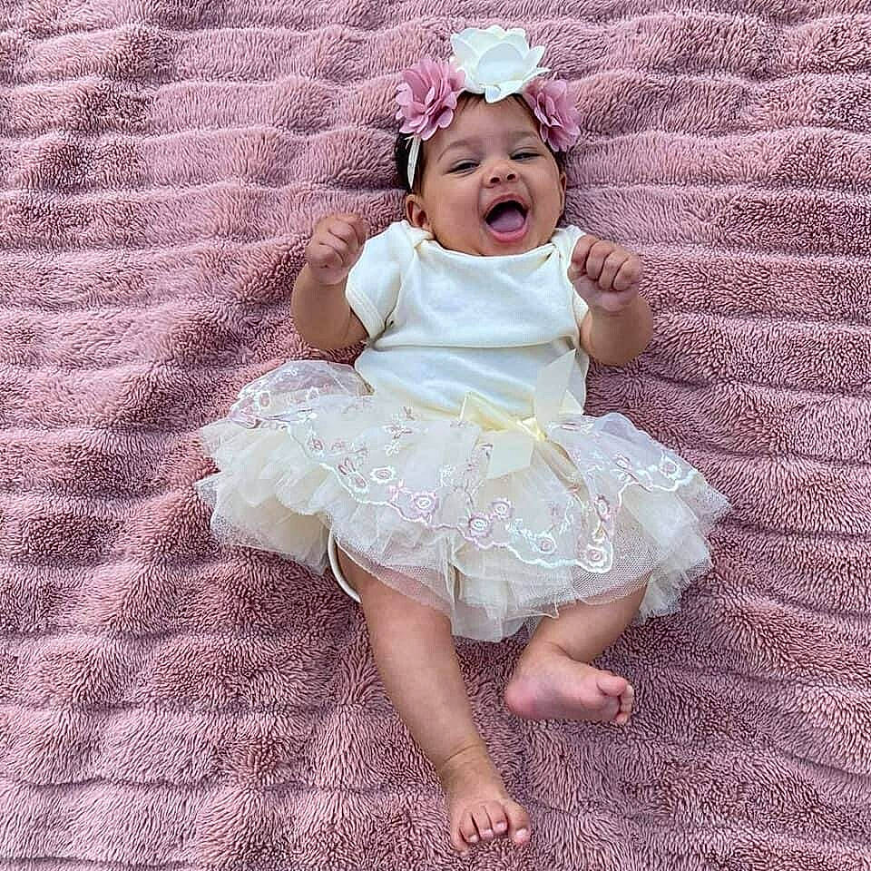 Payton is registered to the contest to win money with this photo: baby, baby_toddler_clothing, child, day_dress, dress, embellishment, eye, hair_accessory, happy, headpiece, headwear, iris, pattern, person, petal, pink, purple, skin, sleeve, smile