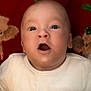 baby, child, closeup, cozy, cute, expression, face, festive, holiday, indoors, infant, mouth_open, newborn, portrait, red_background, reindeer_toy, soft_toys, white_clothing, wide_eyes, winnie_the_pooh