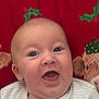 Tjay is registered to the contest to win money with this photo: baby, cheerful, child, christmas, clothing, cute, expression, face, happy, holiday, holly, indoors, infant, plush_toy, portrait, red_background, reindeer, smile, striped_shirt, young