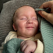 Tjay joined the competition — help win amazing prizes! baby, smile, sleeping, blanket, knitted, hand, cozy, comfort, soft, face, infant, cute, warm, skin, clothing, closeup, person, rest, peaceful, indoors